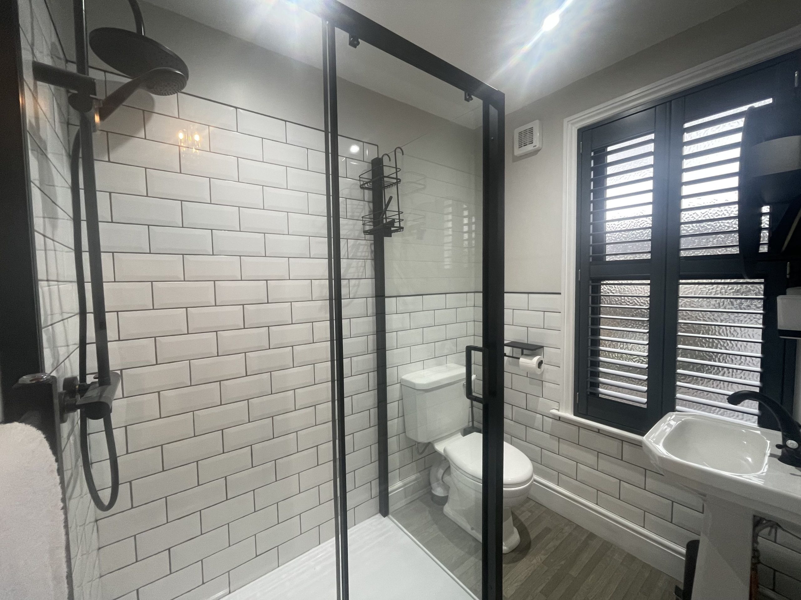 walk in waterfall shower, sink, WC and heated towel rail. Towels are provided.
