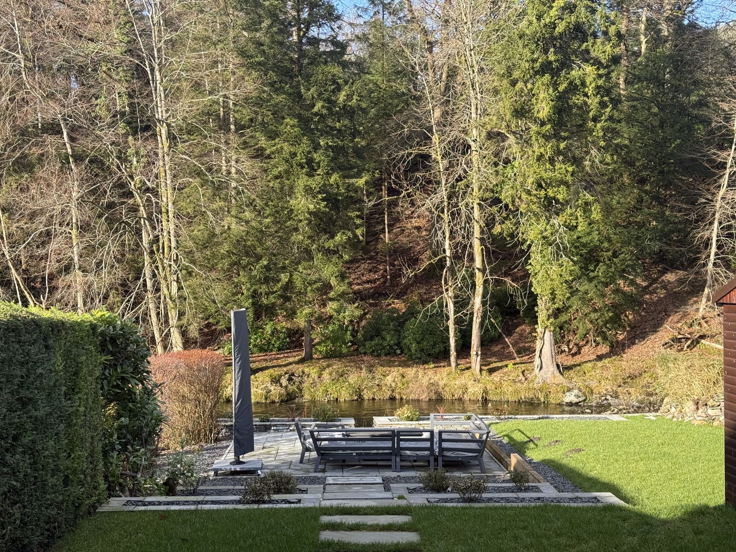 beautiful deck complete with outdoor sofa and parasol for those lazy days by River Greta