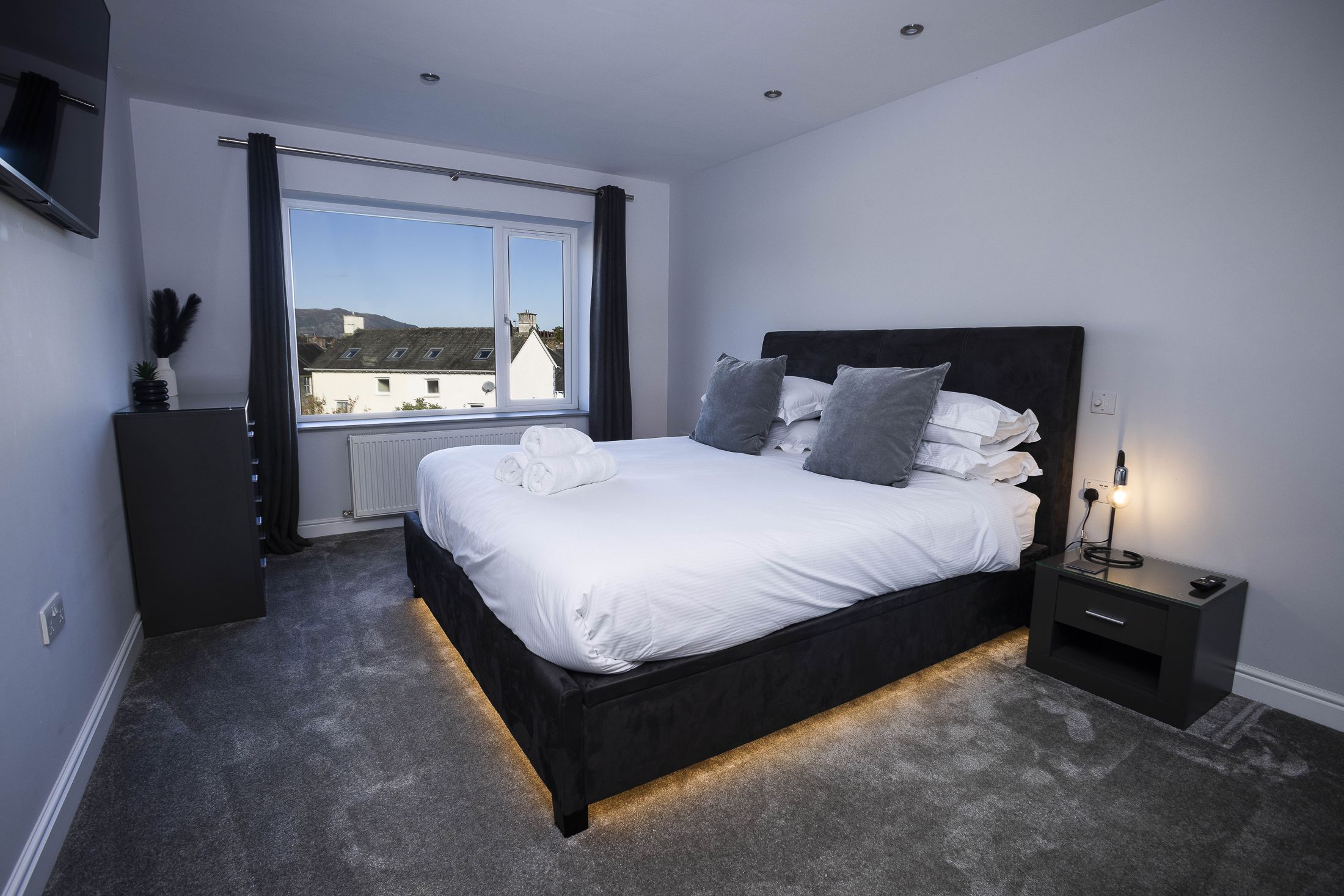 Under-bed lighting adds a touch of modern warmth and charm.