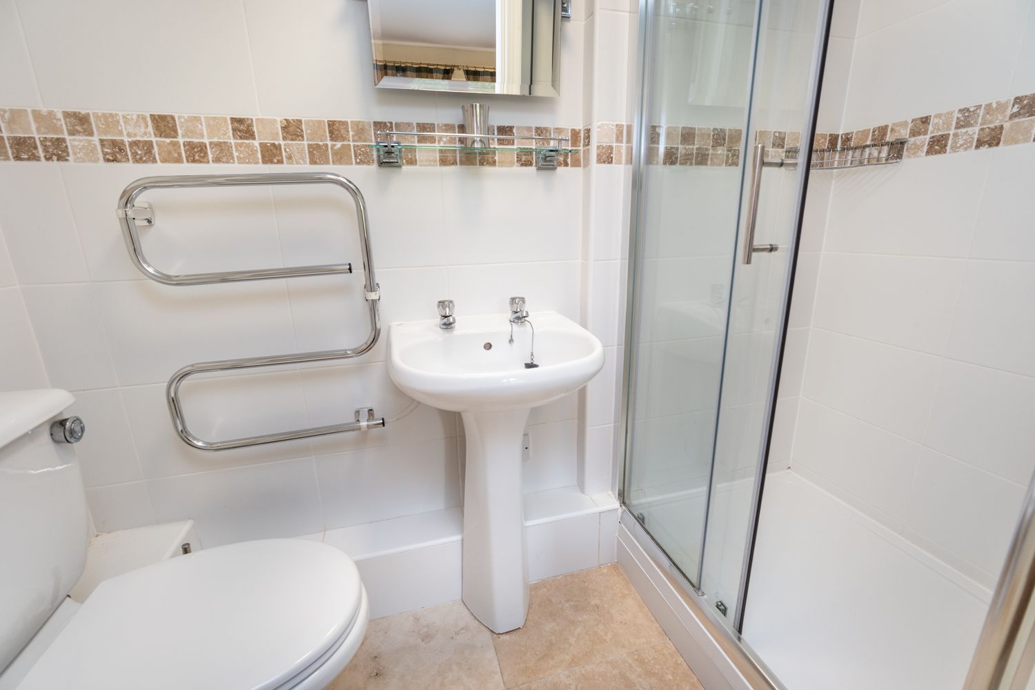 The ensuite bathroom includes a walk in shower and heated towel rail