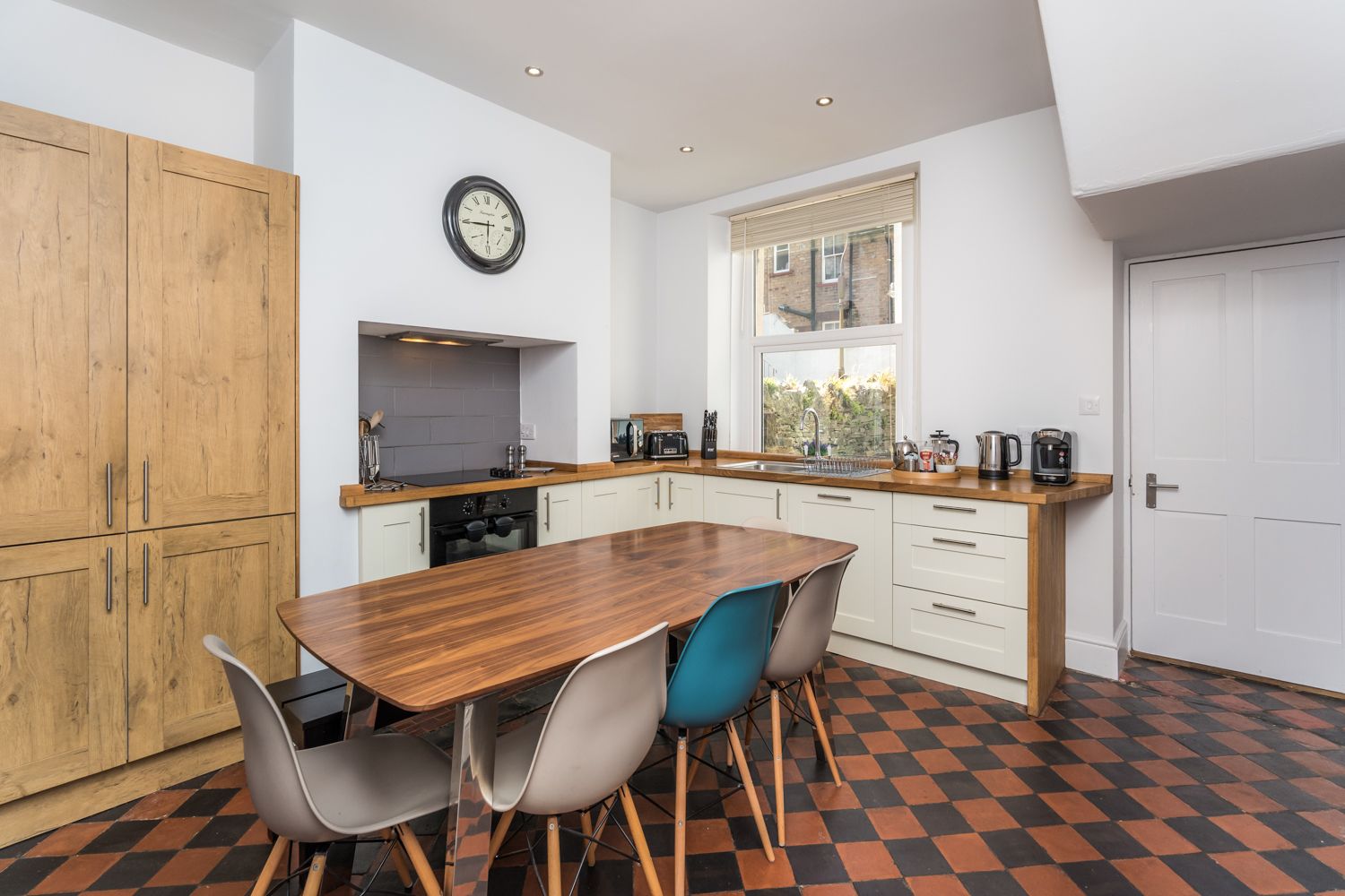 The ground floor kitchen is spacious and has a large dining table for everyone to enjoy meals together