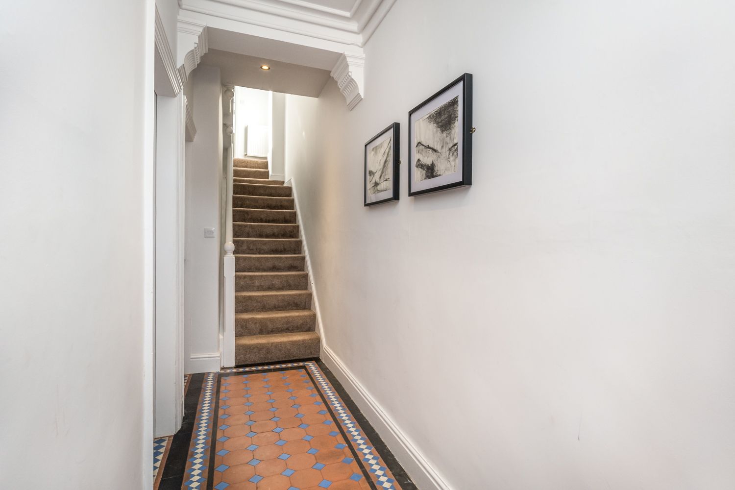 The property retains the original tiled flooring in the hallway