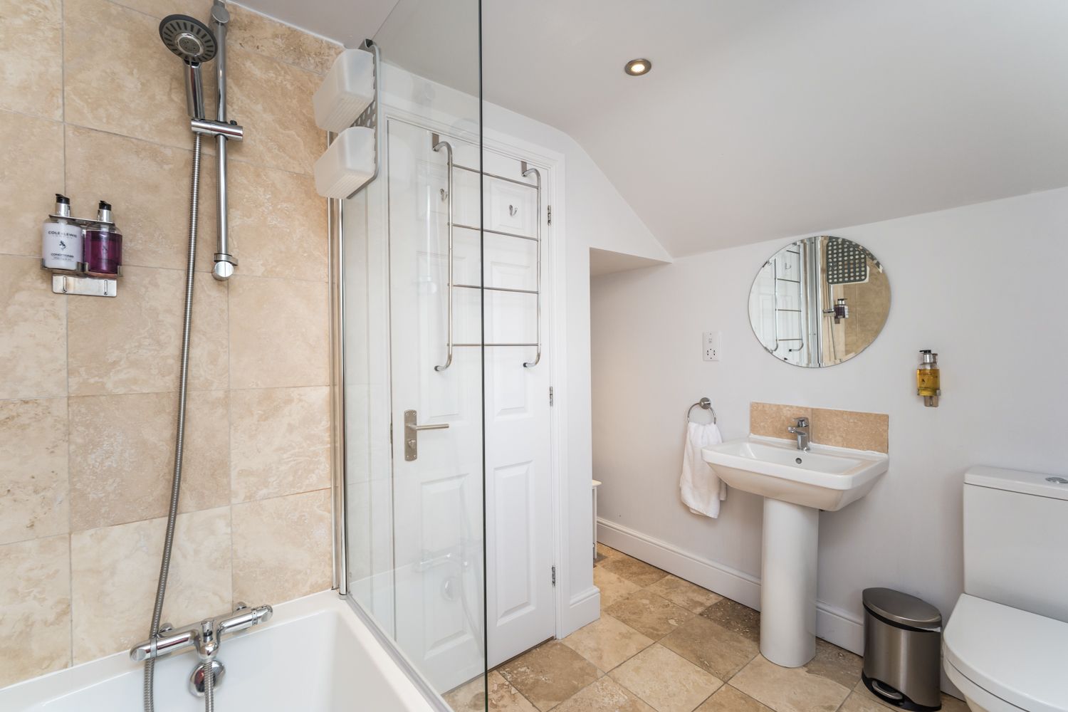 The bathroom comprises bath with overhead shower, hand sink and WC