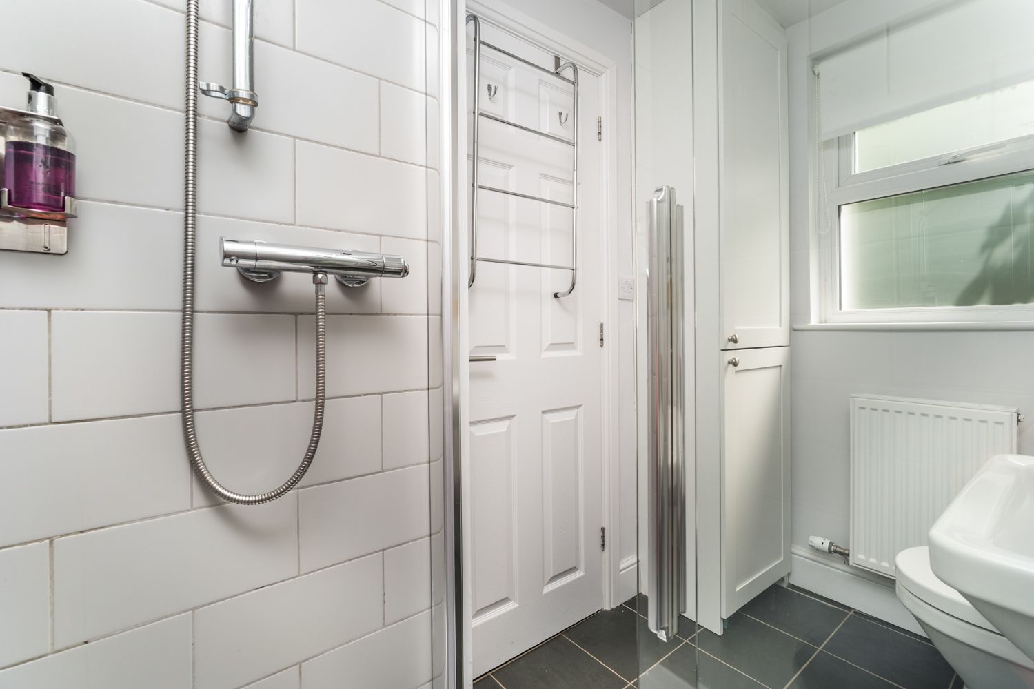 The downstairs shower room can be accessed from the rear hallway, past the kitchen