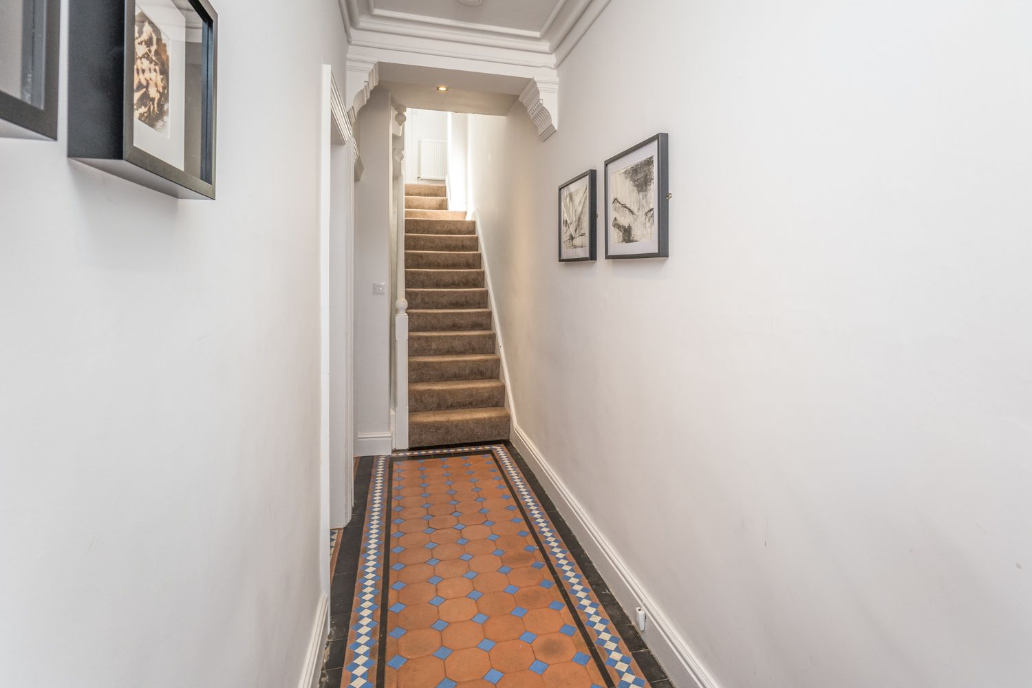 The property retains the original tiling in the hallway