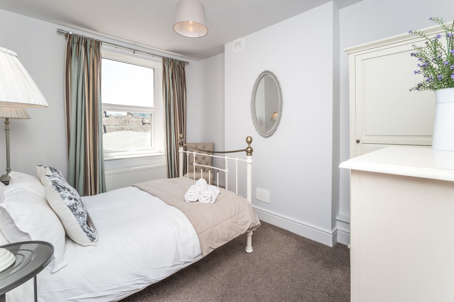 The property is furnished with a double bed, wardrobe, chest of drawers and bedside tables