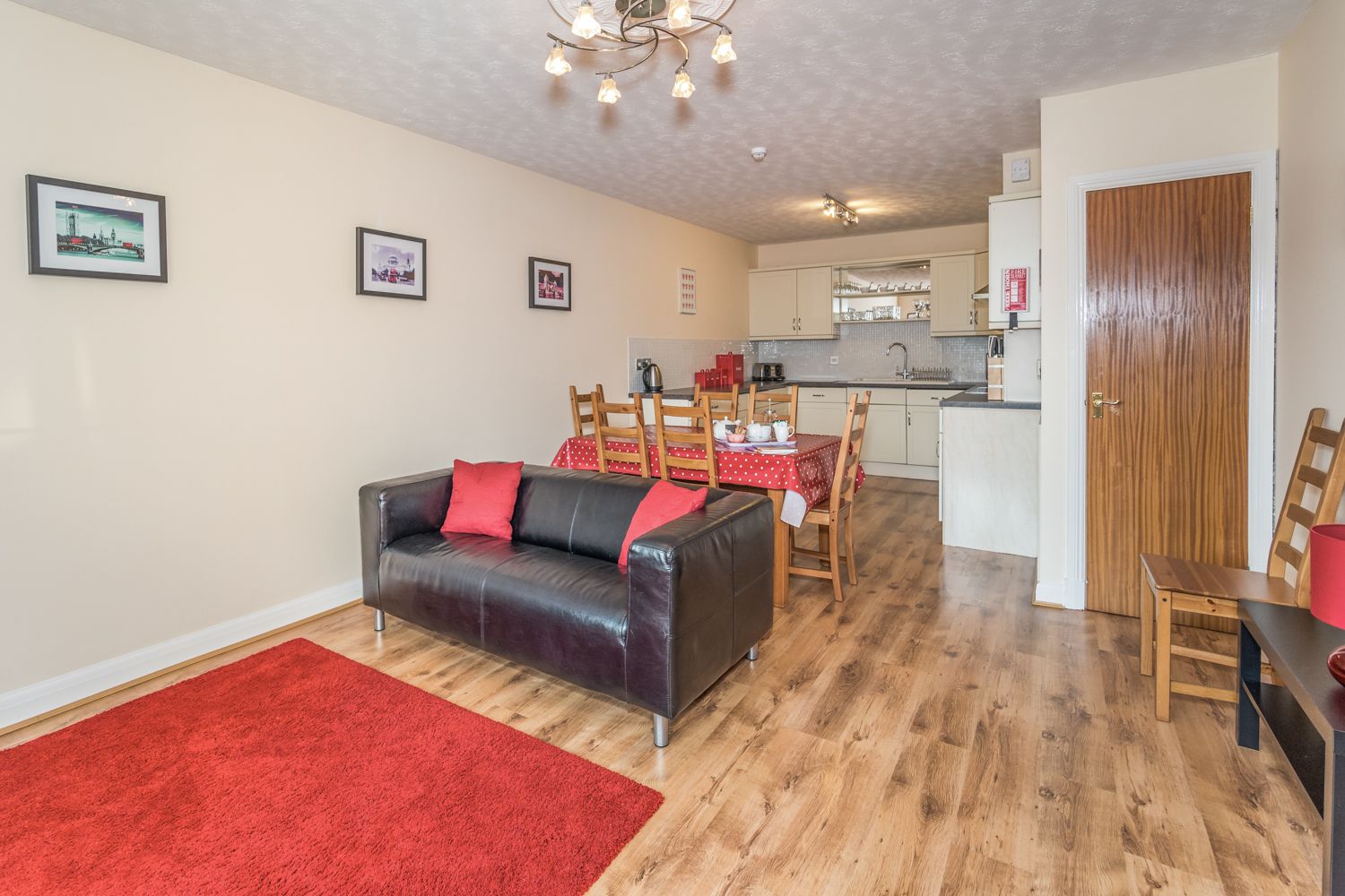 The large open plan kitchen and dining area is also furnished with a sofa and smart TV