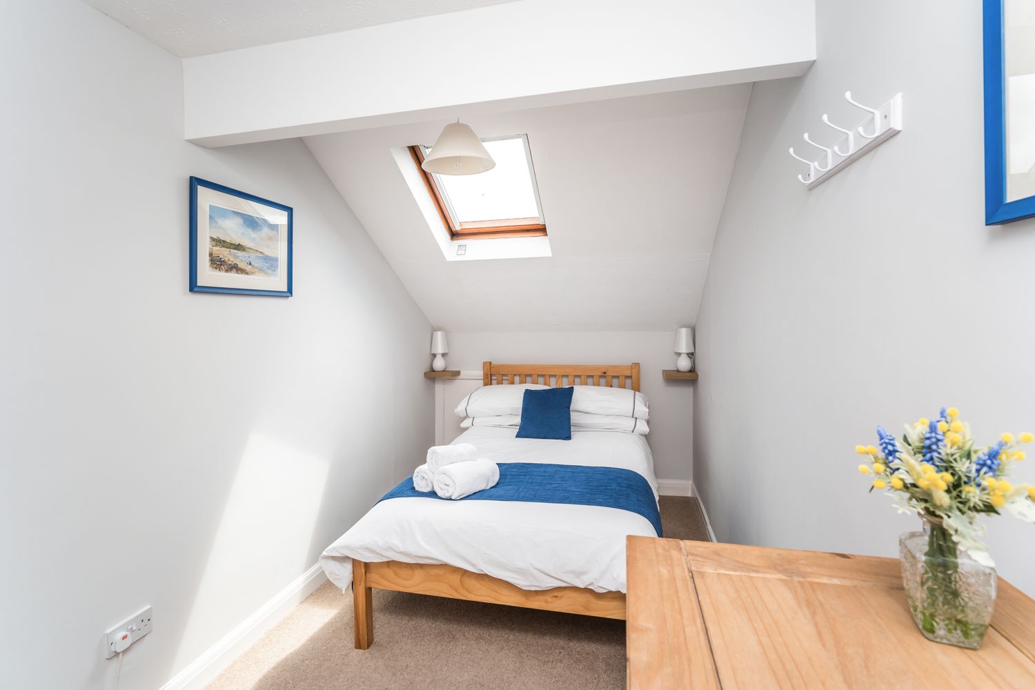 Hooks and a chest of drawers is also provided