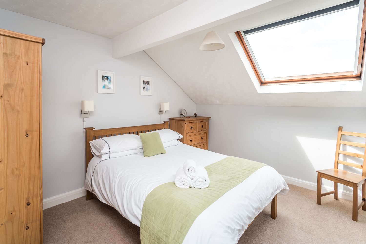 The master bedroom is furnished with a king sized bed, wardrobe and chest of drawers