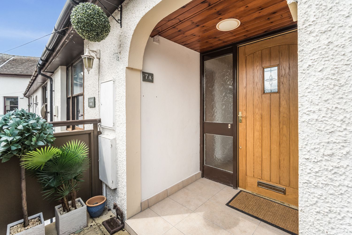 An external staircase leads to the front entrance of the property