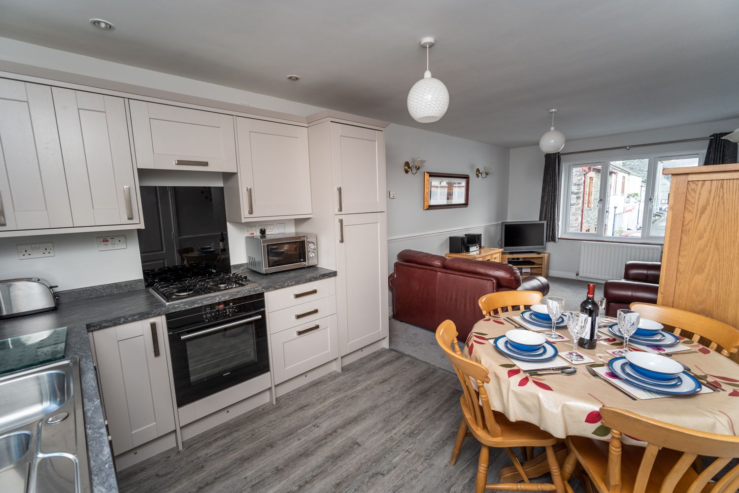 The open plan living area and kitchen is spacious and airy