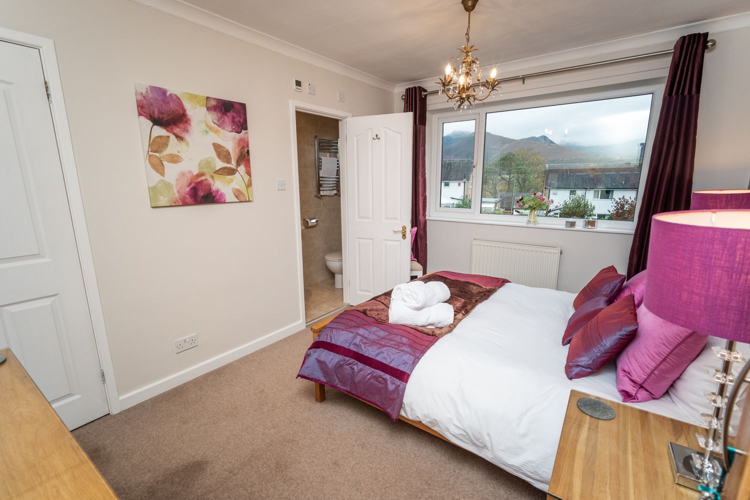 The master bedroom is spacious and commands spectacular mountain views