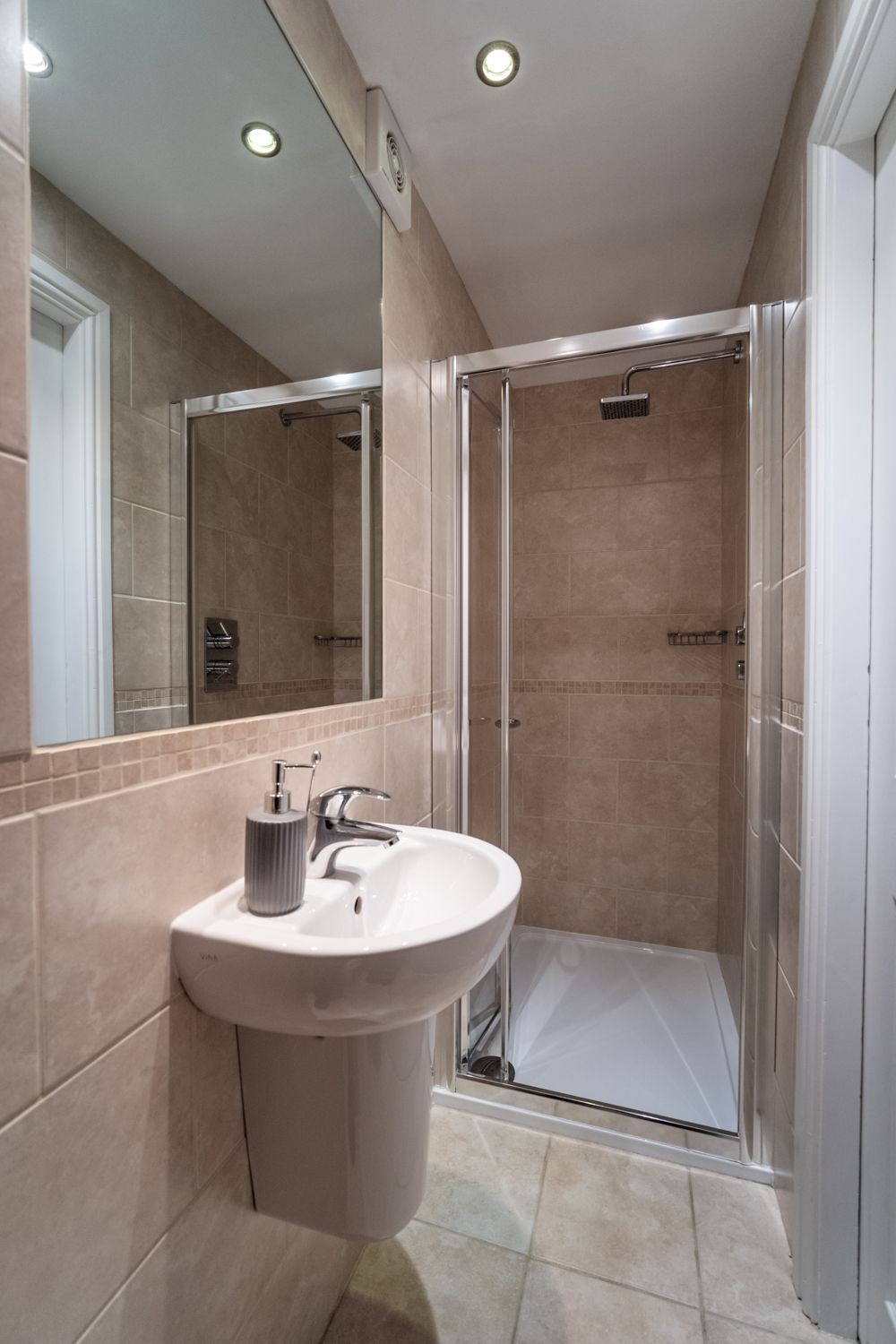 The downstairs shower room can be found off the downstairs hallway