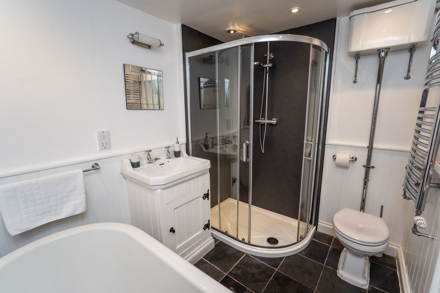 The family bathroom comprises roll top bath and walk in shower