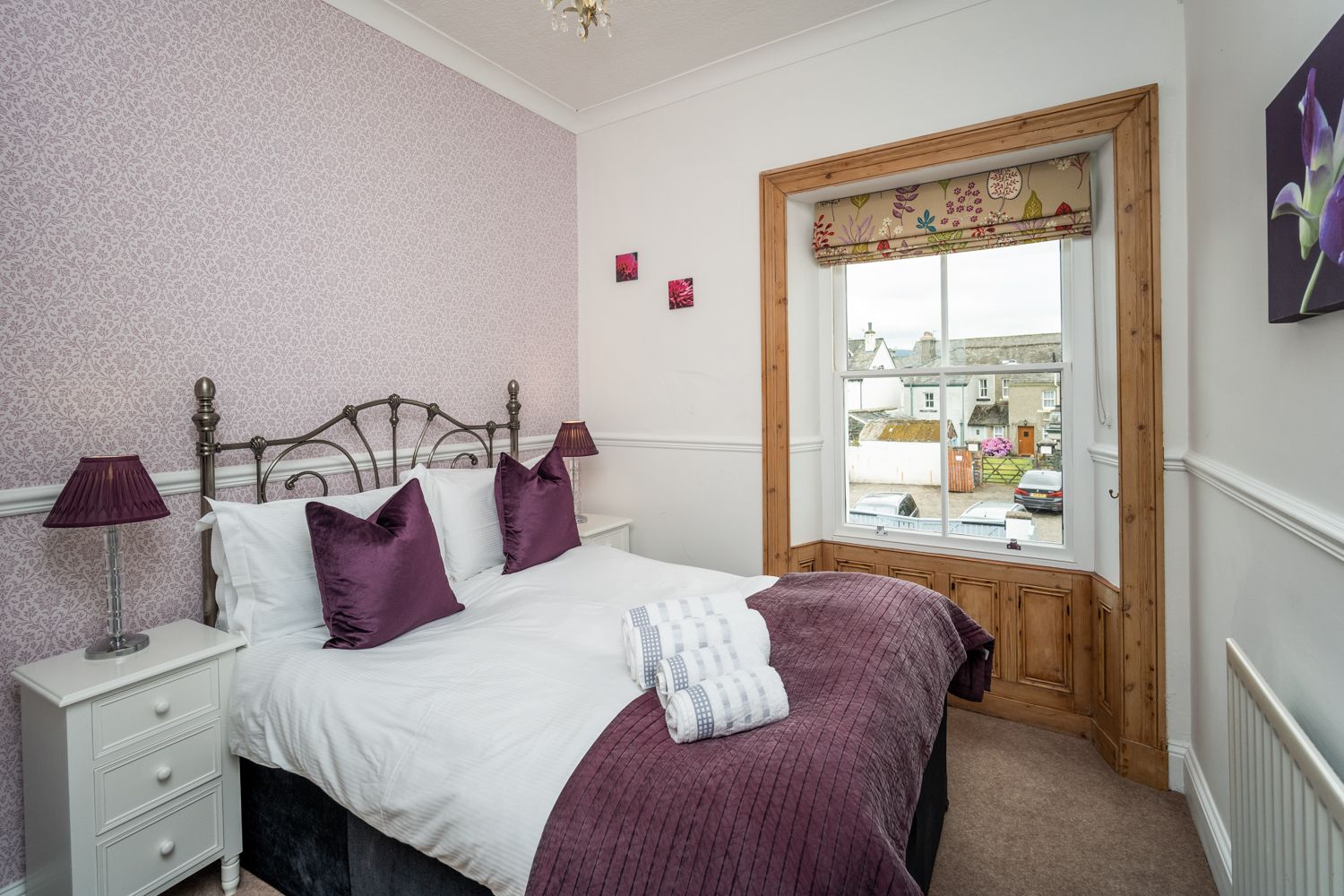 The second bedroom features a double bed, bedside tables and wardrobe