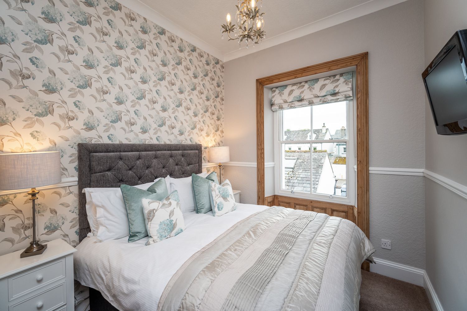 The master bedroom features a kingsize bed, bedside tables, wardrobe, drawers and wall mounted TV