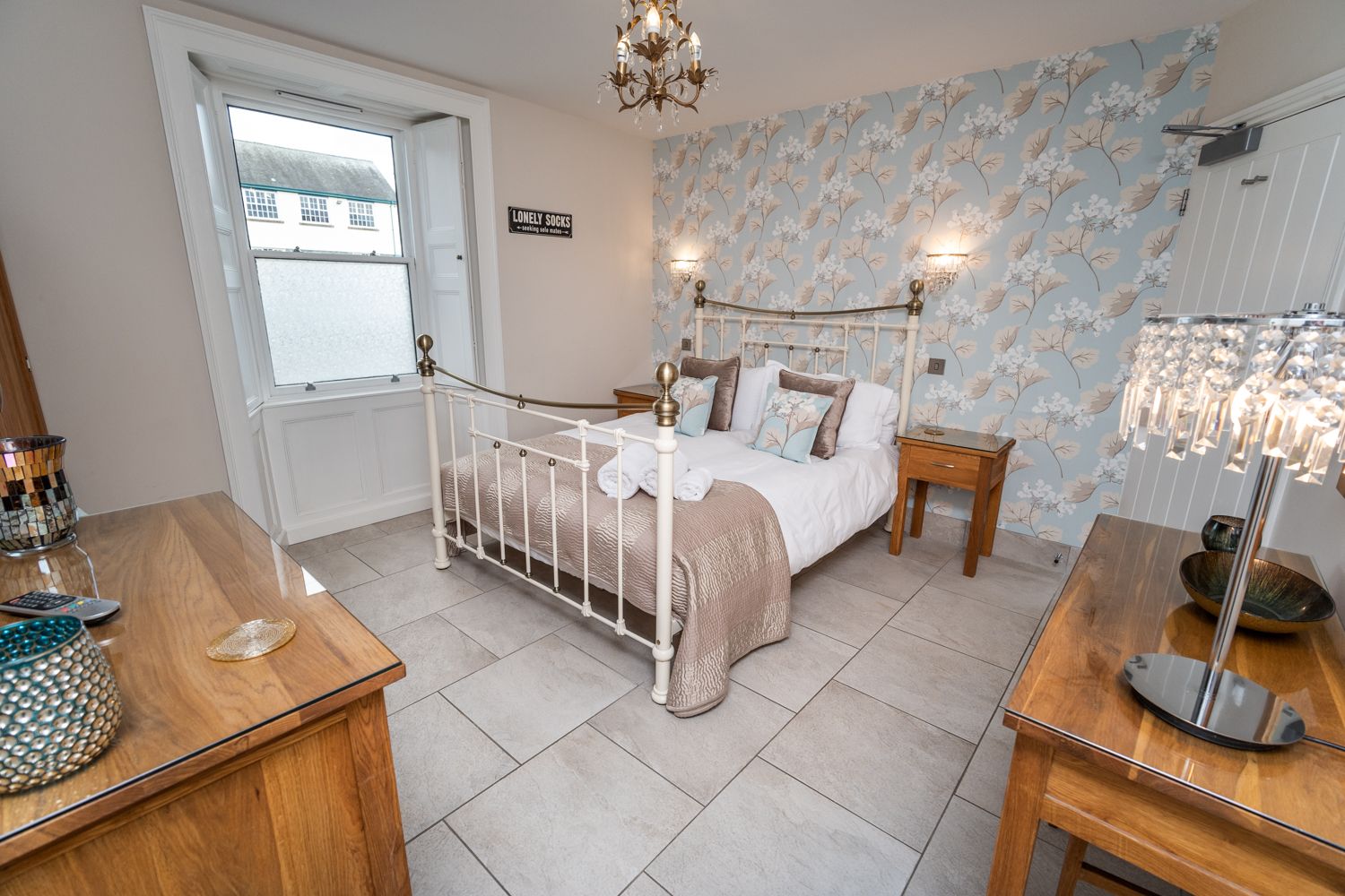 The room is also furnished with a wardrobe, drawers, dressing table and bedside tables