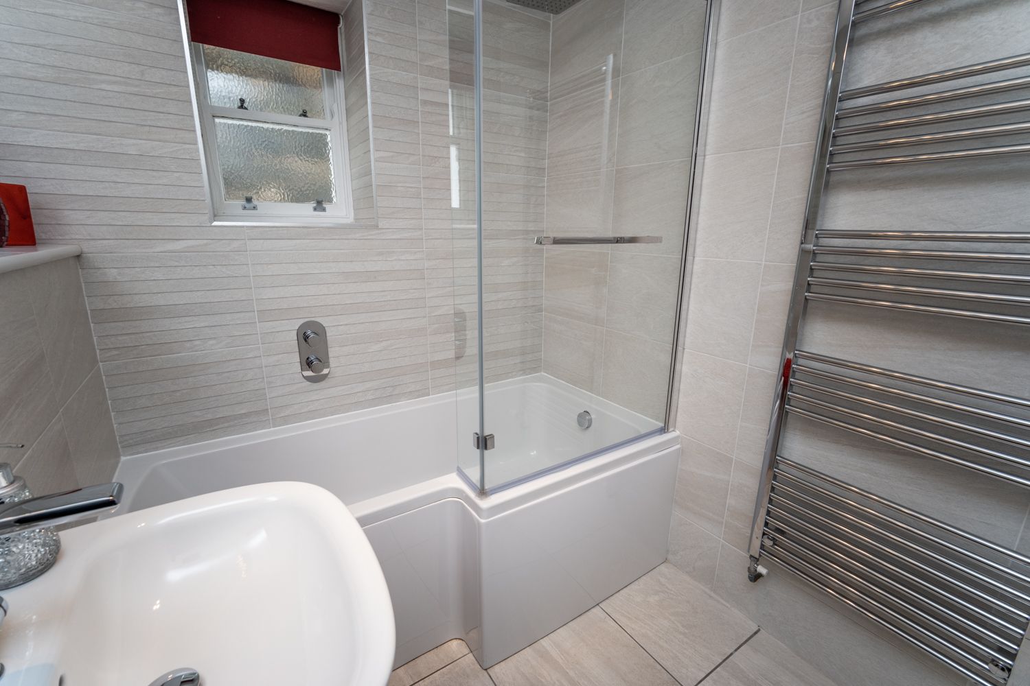 The main bathroom has a large L-shaped bath with overhead rainfall shower