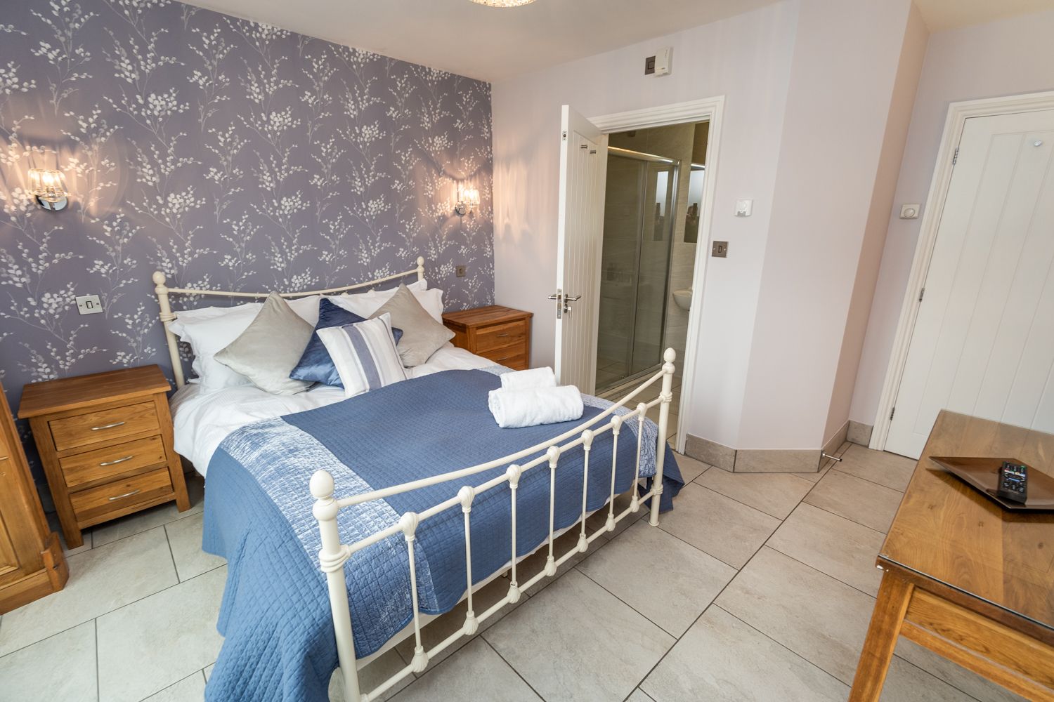 The master suite features a king size bed and built in wardrobe