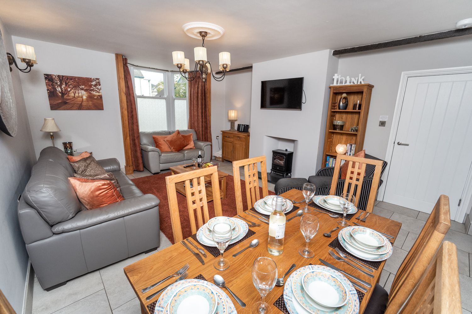 The living features an electric stove, underfloor heating and wall mounted TV