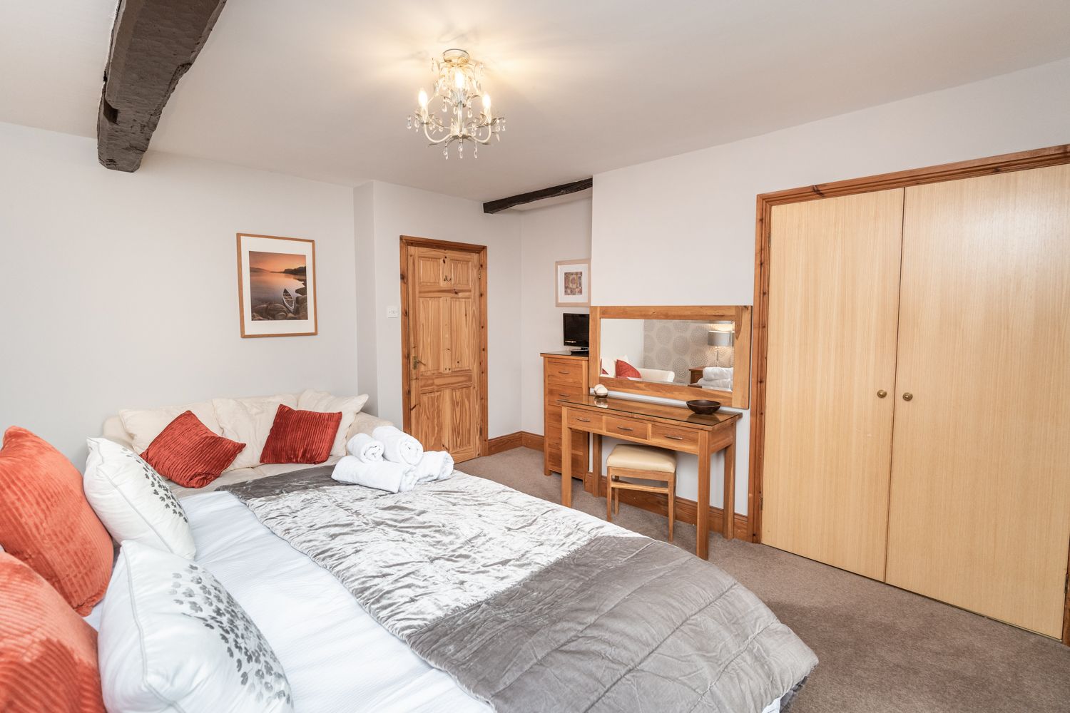 There is ample storage area in this bedroom thanks to a large built in closet