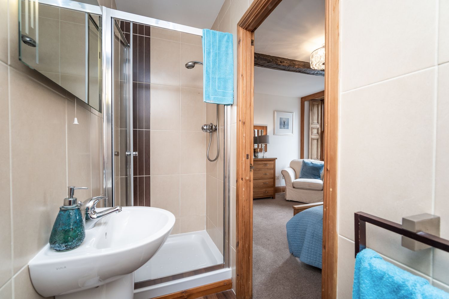 The modern ensuite has a walk in shower, hand basin and WC