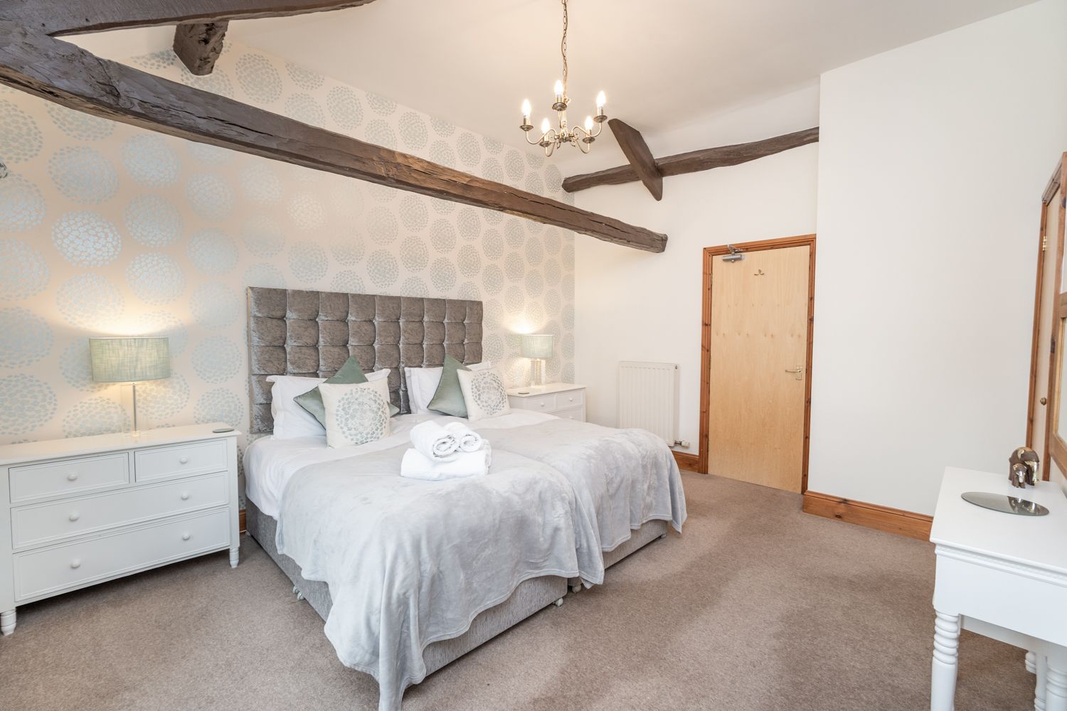 This bedrooms features 2 single beds, dressing table, built in closet and drawers