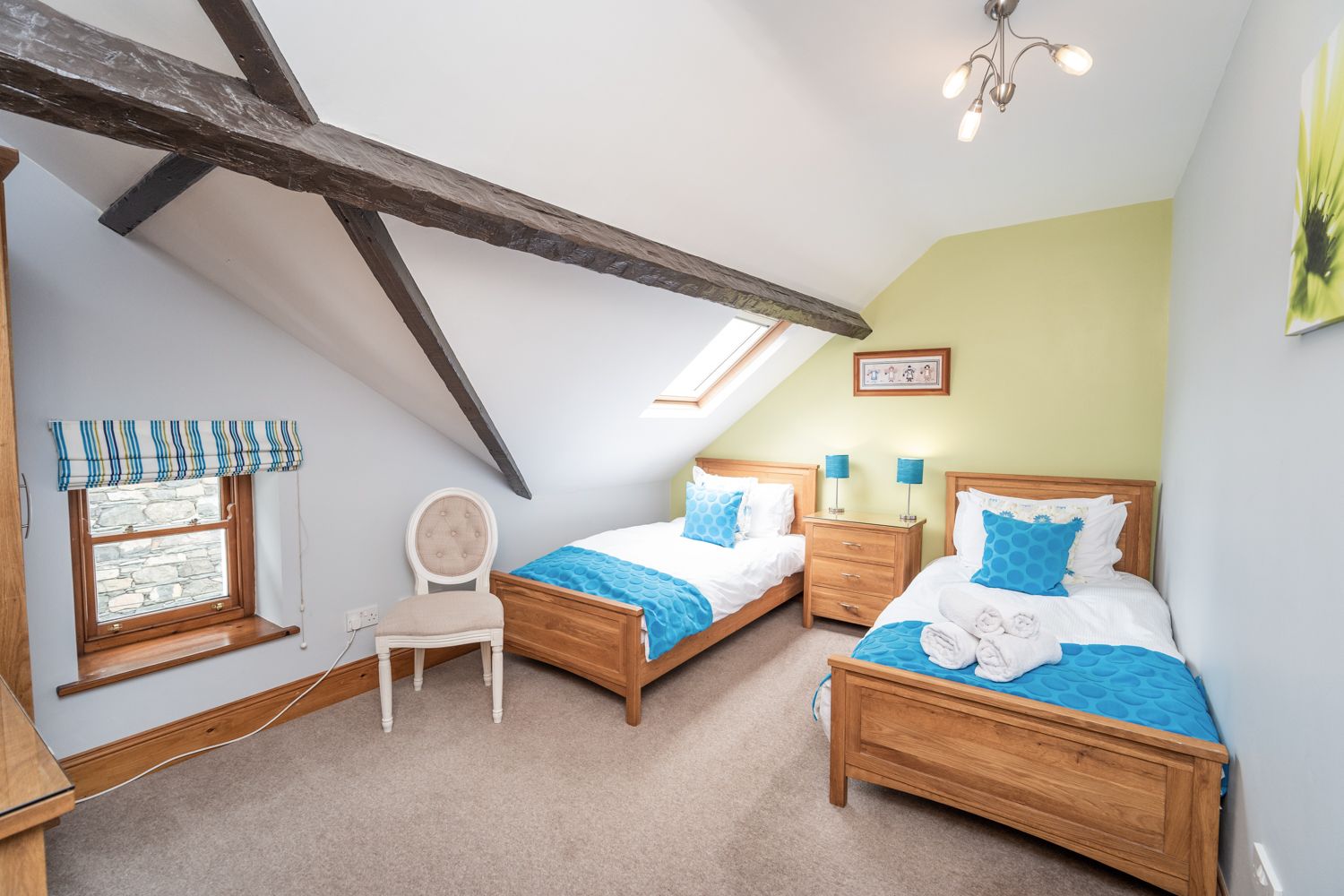 A pretty twin room with 2 single beds, wardrobe and drawers