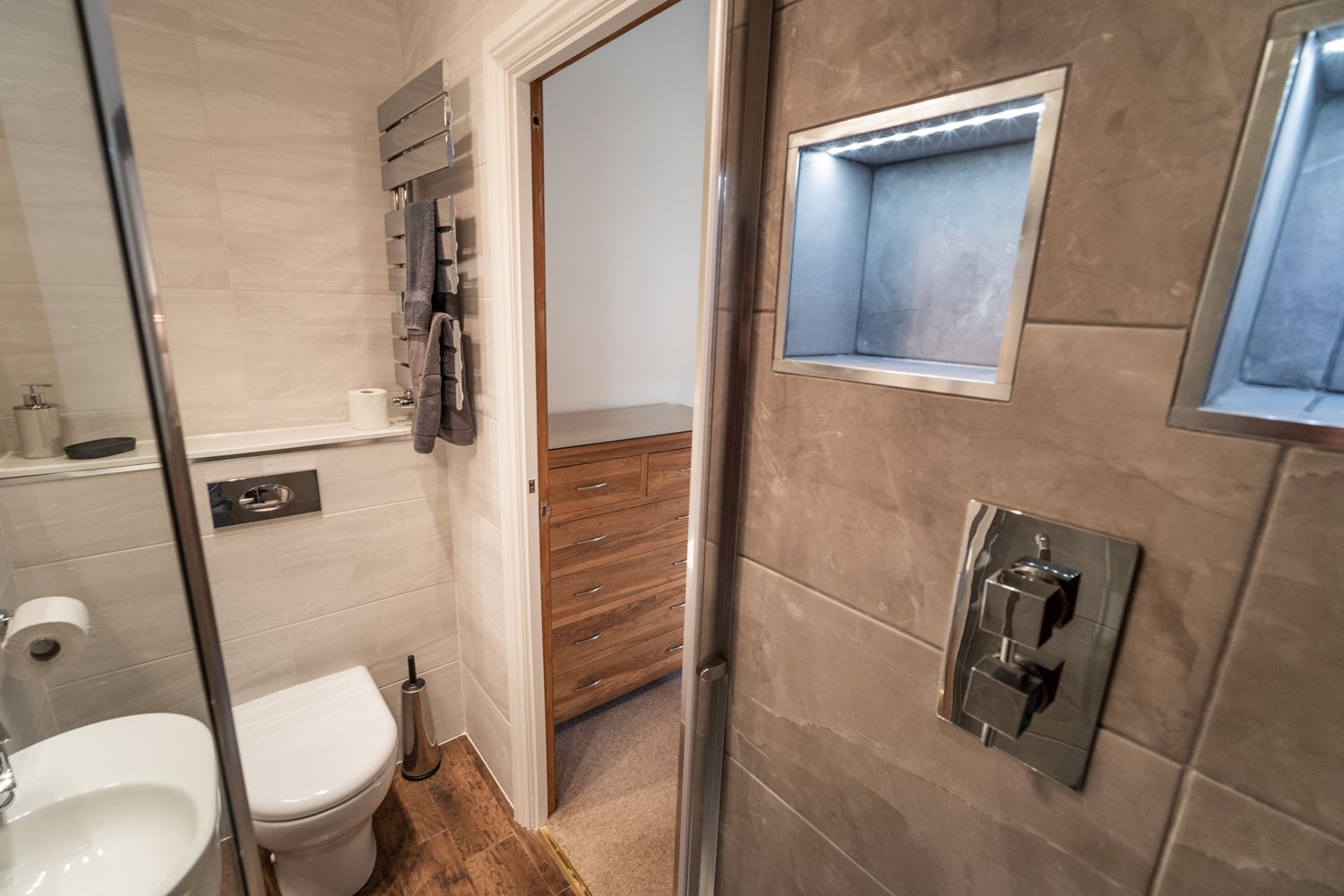 The bathroom is modern and features a rainfall shower