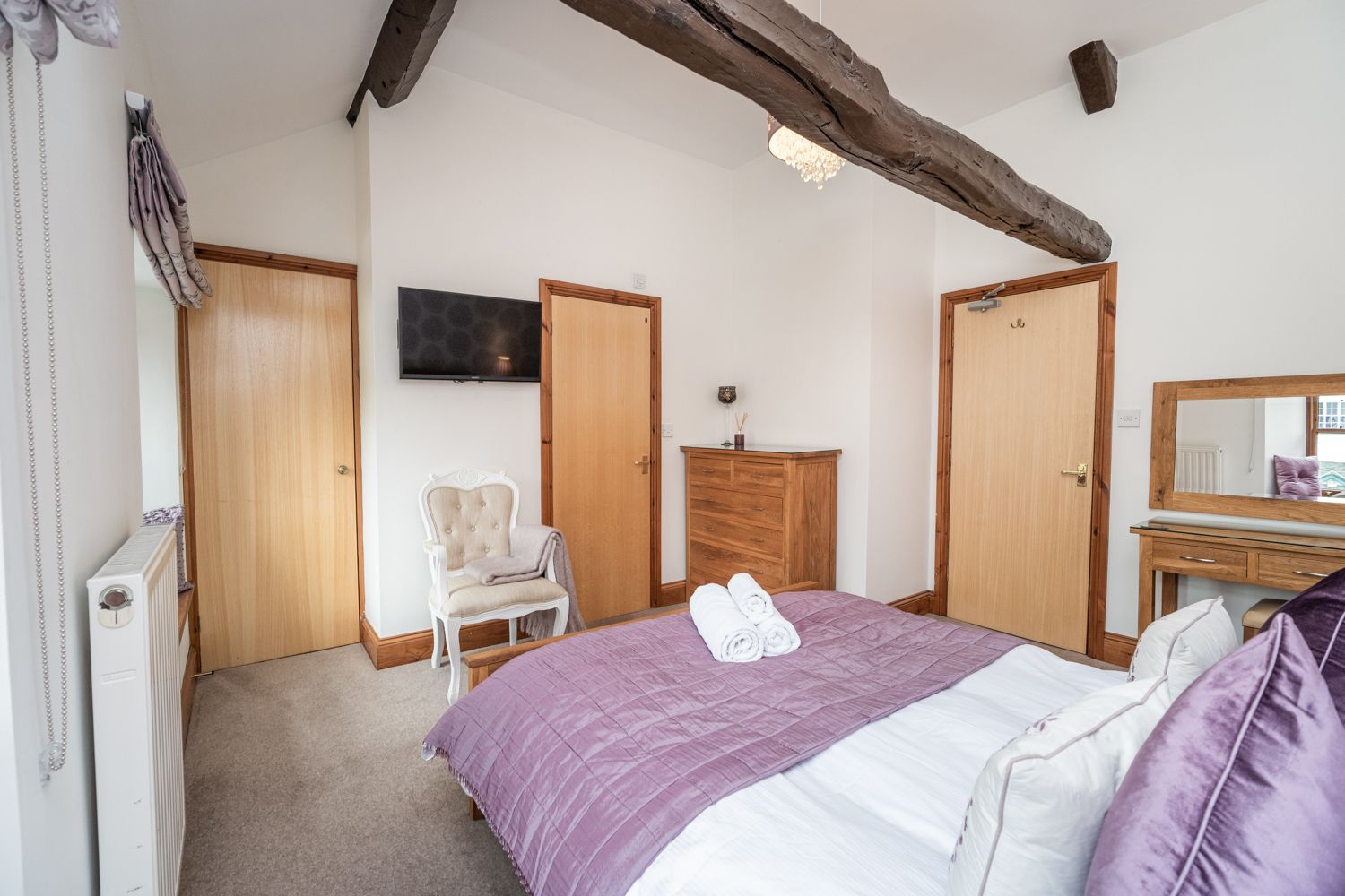 The bedroom features a king sized bed and ensuite shower room