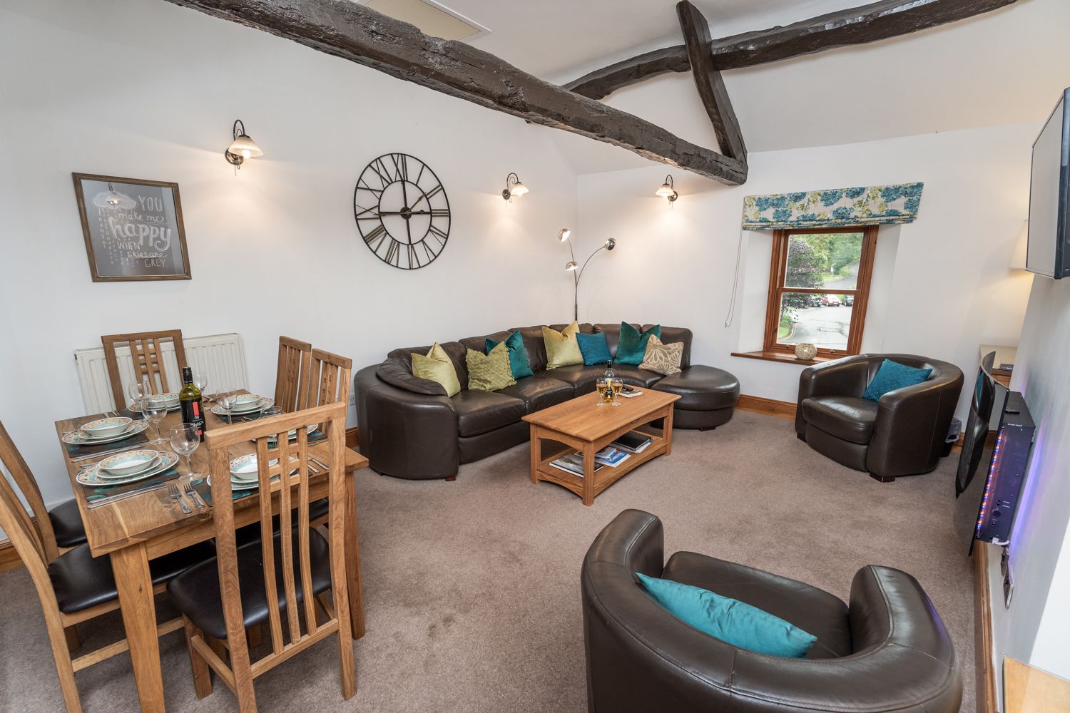 The open plan living area is full of character, with gorgeous high beamed ceilings 