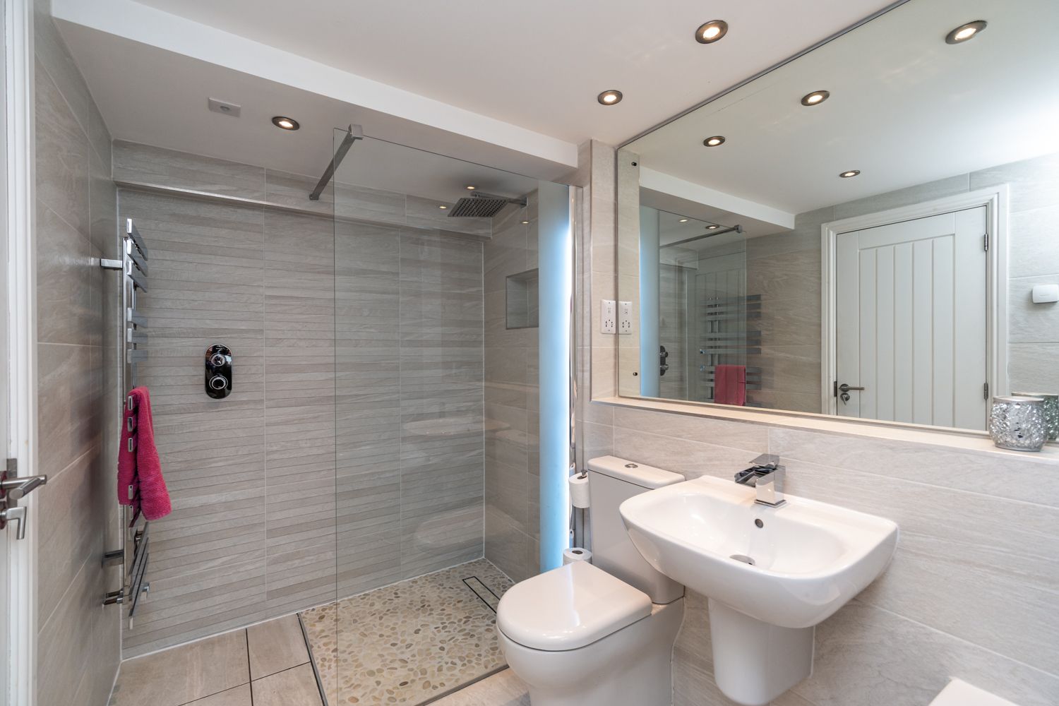 The ensuite bathroom comprises of a large walk in shower, bath, hand sink, heated towel rail and WC