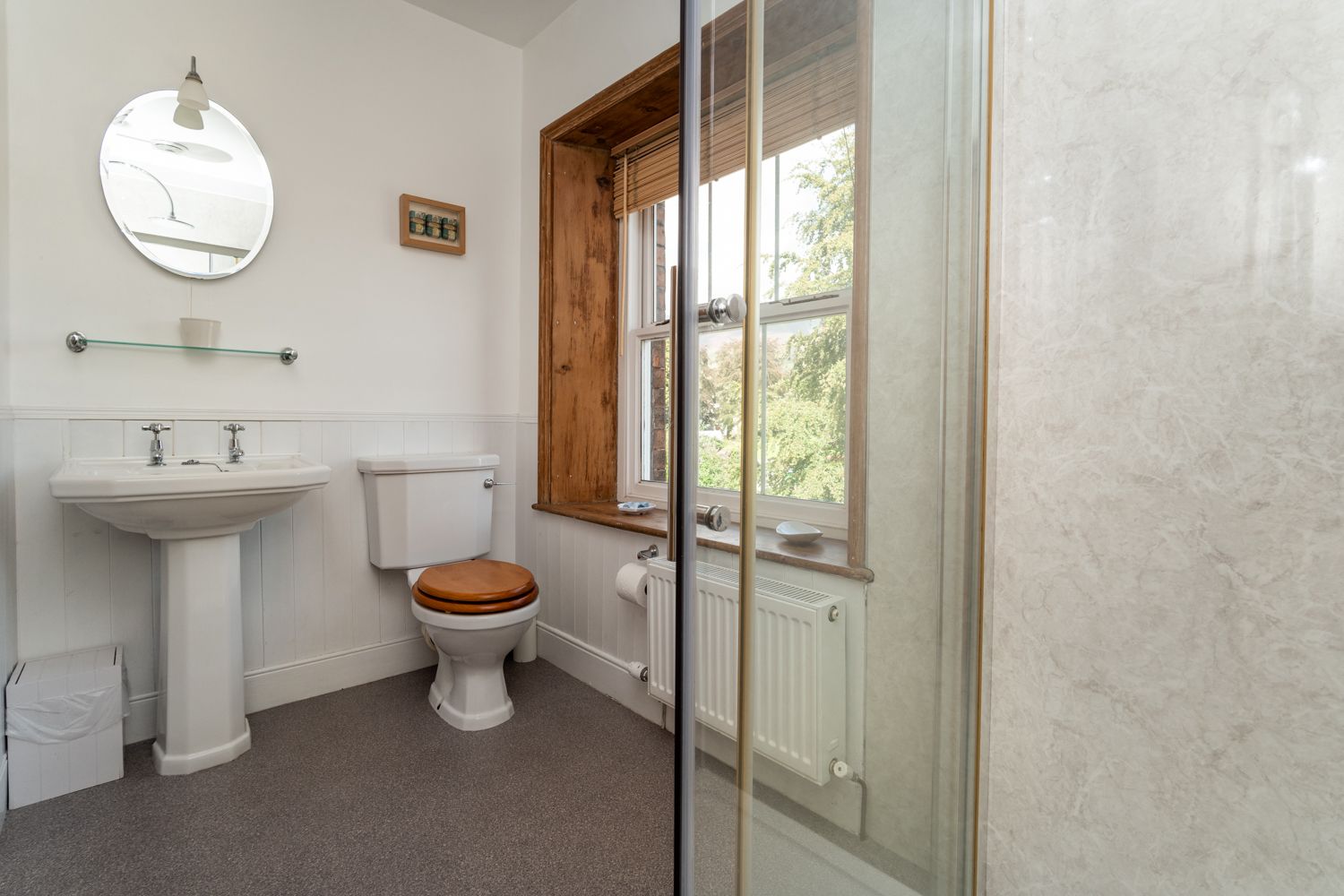 The bathroom is well lit and has plenty of space