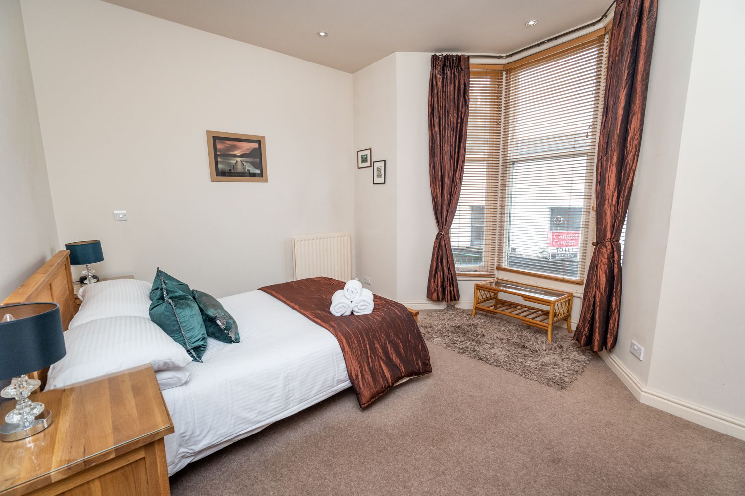 The bedroom enjoys a beautiful bay window with views over Station Street