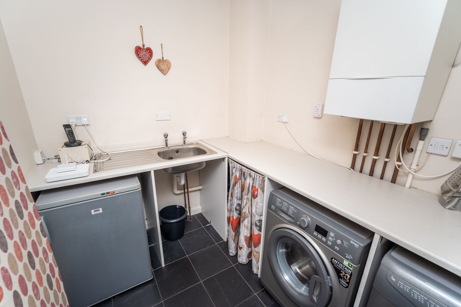 The well equipped utility area with room to store coats and boots
