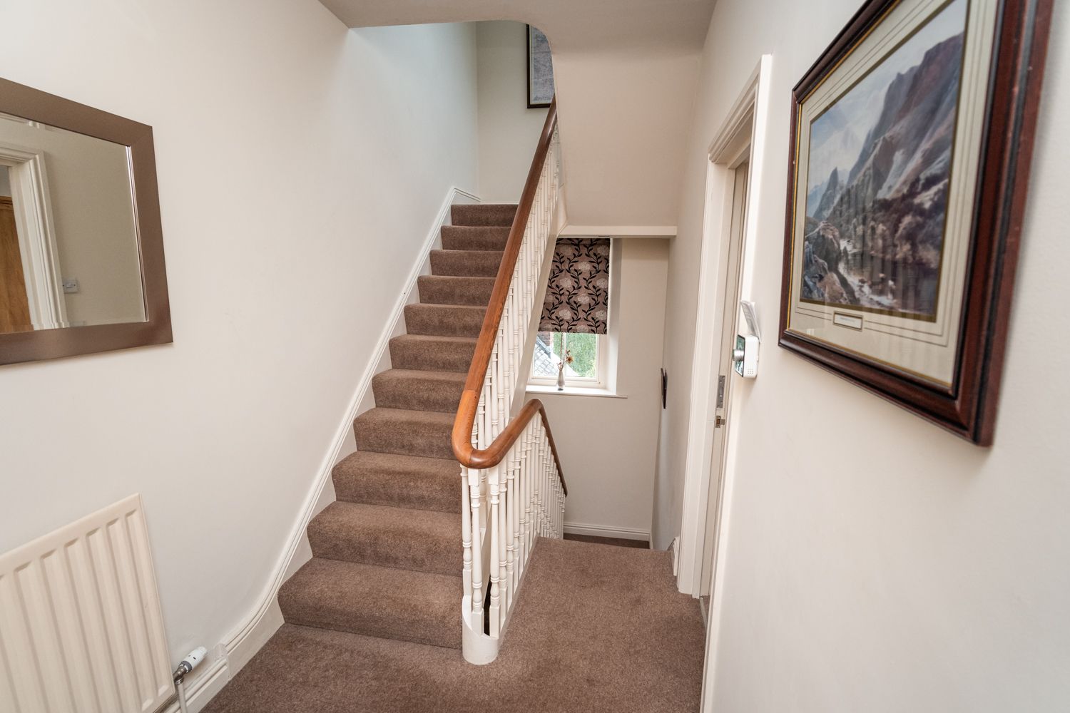 The staircase leads from the hallway to the open plan third floor living, dining and kitchen area
