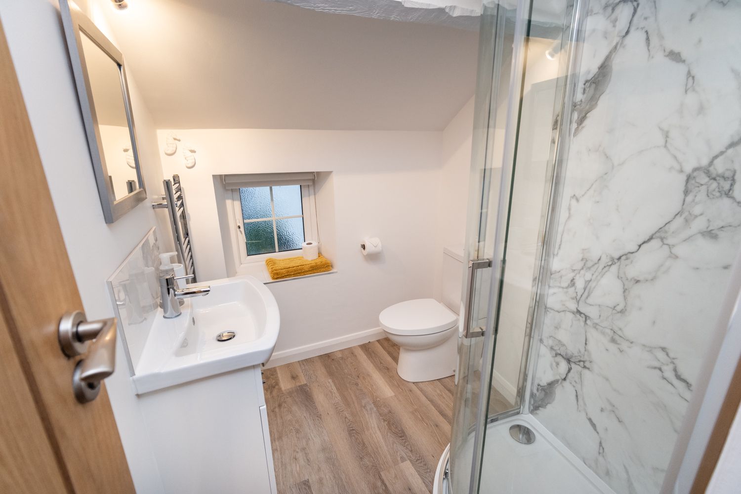 A compact and modern shower room is accessed from the twin bedroom