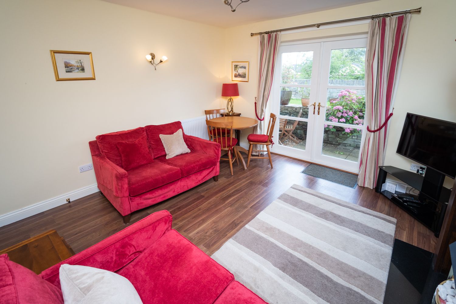 Double doors lead to the enclosed patio area with views of River Greta