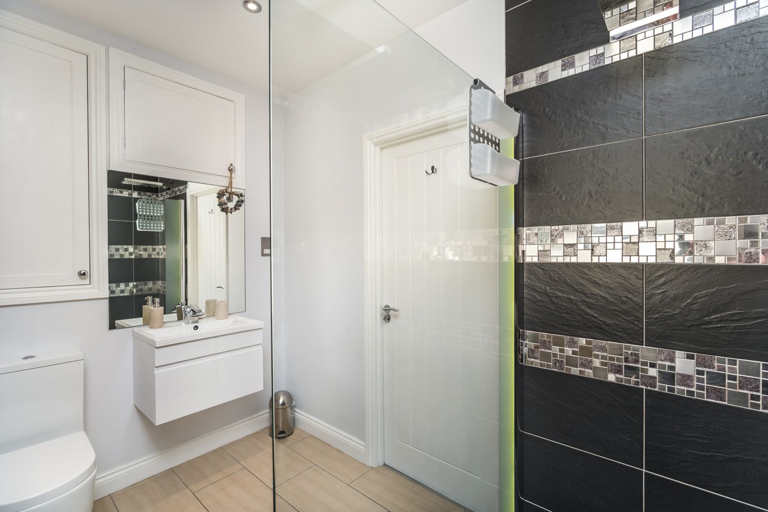 The modern bathroom has a large walk in shower