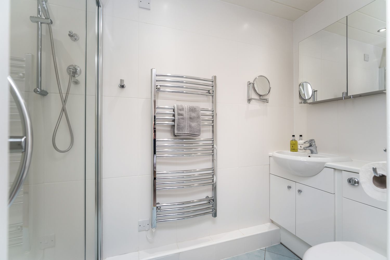 The ensuite features a walk in shower and heated towel rail