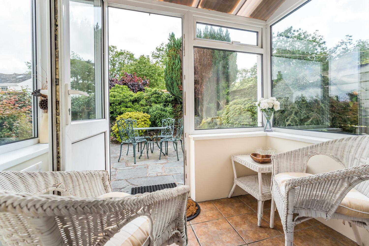 At the rear of the property you will find a small sun room with comfortable wicker chairs and table, ideal for afternoon tea and reading