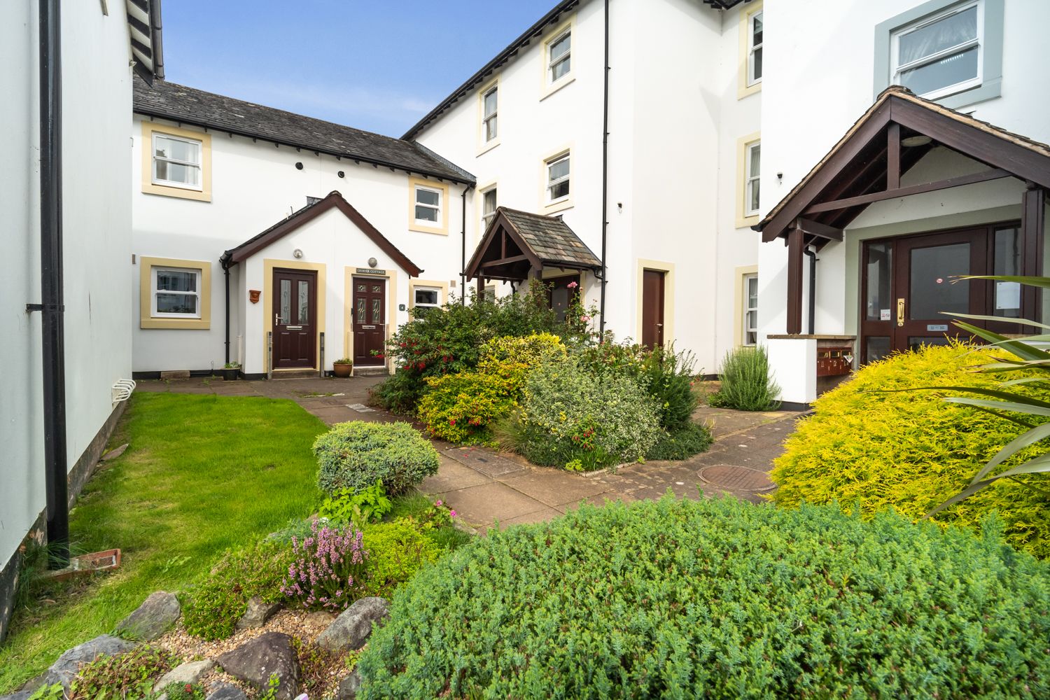 The entrance to the property is located in the courtyard just beyond the car park