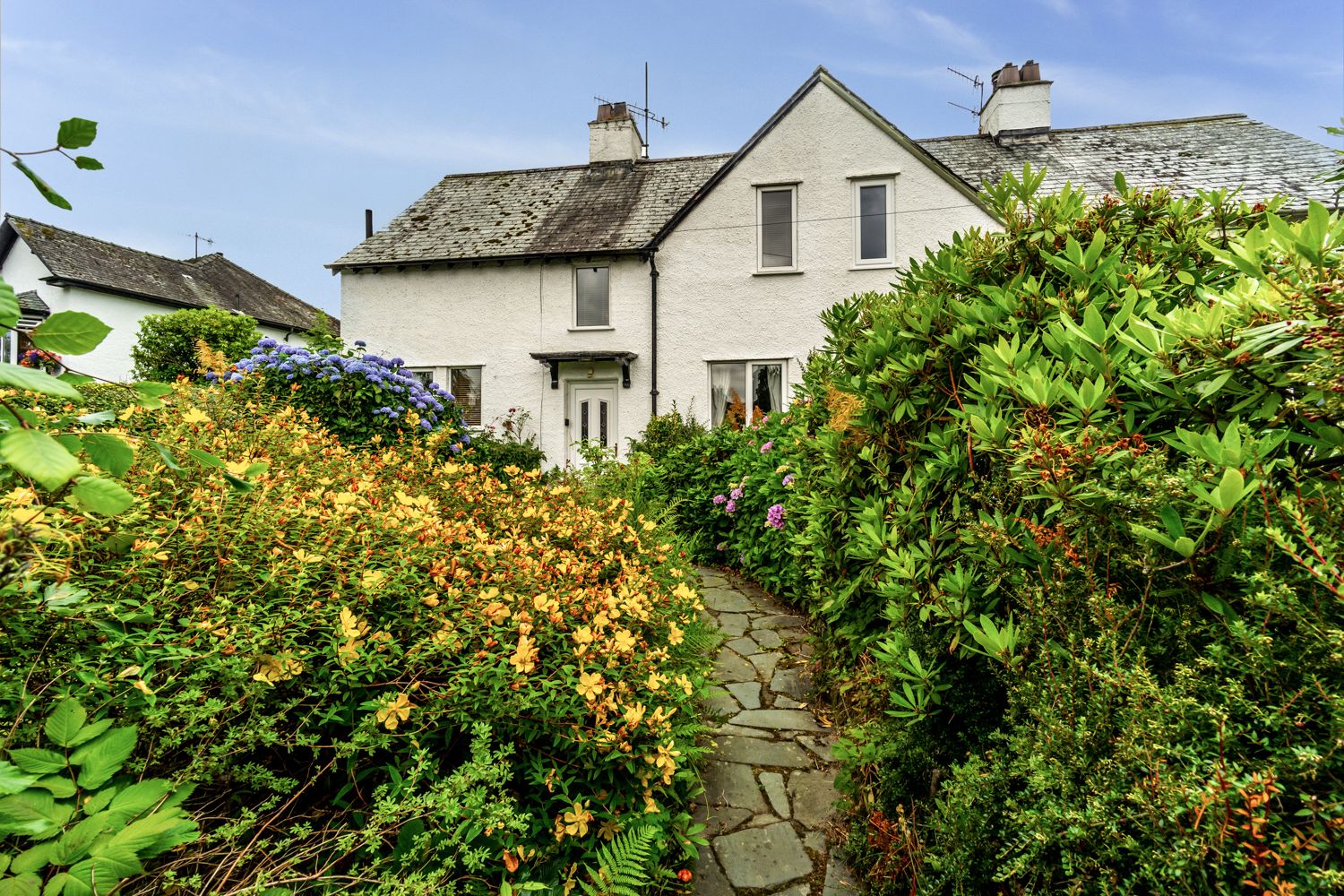 Access to the entrance is either via the path from the roadside or from the private driveway