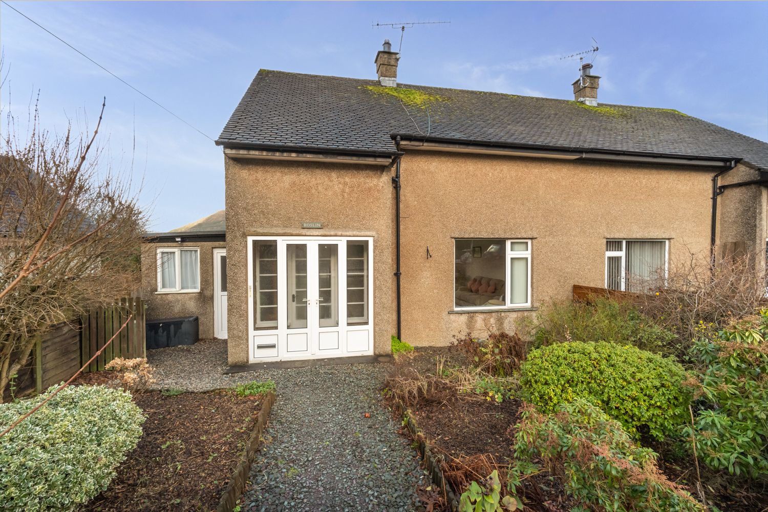 The parking spaces are located in front of the garden