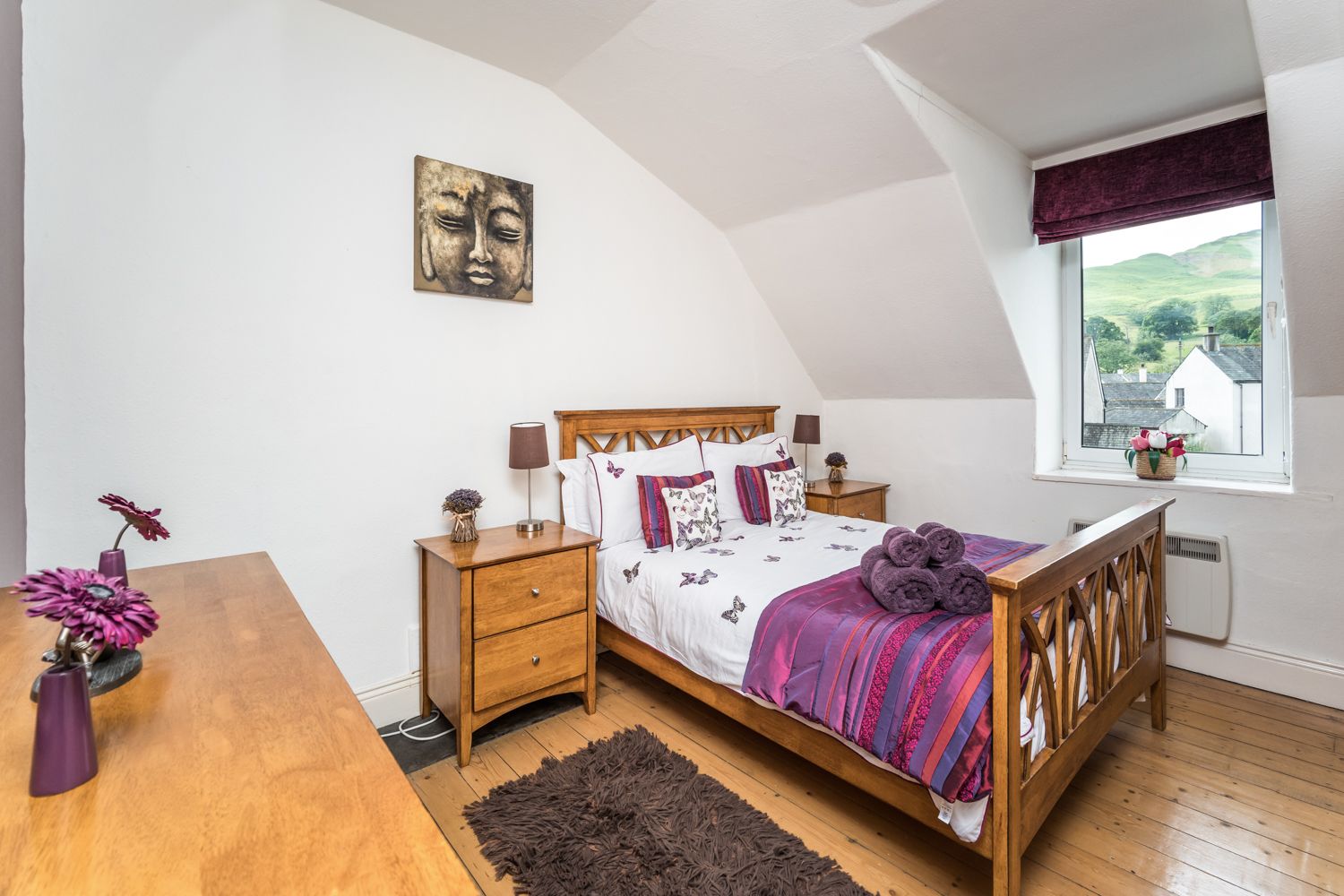 The master bedroom is spacious and features a double bed