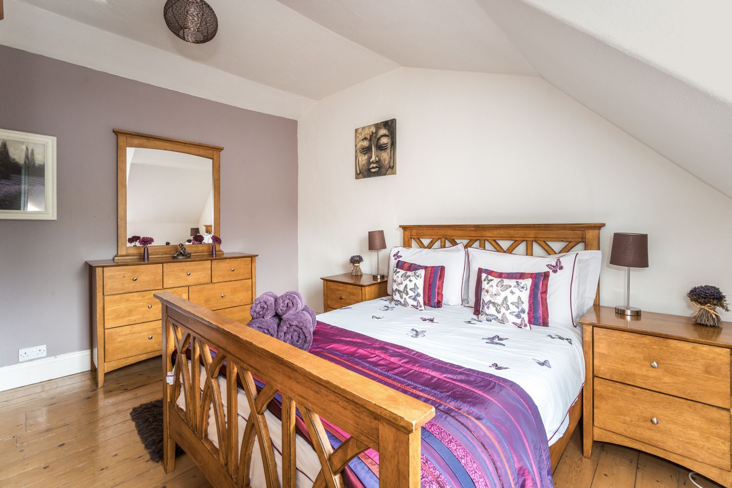 The bedroom also features wardrobe, chest of drawers and bedside tables