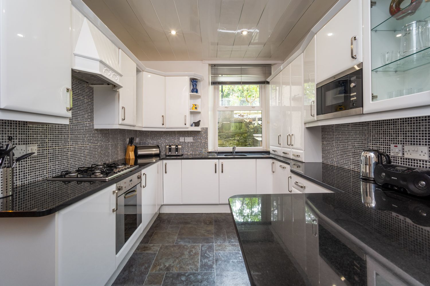 The modern kitchen is equipped with dishwasher, fridge/freezer, electric hob, oven, microwave and washing machine