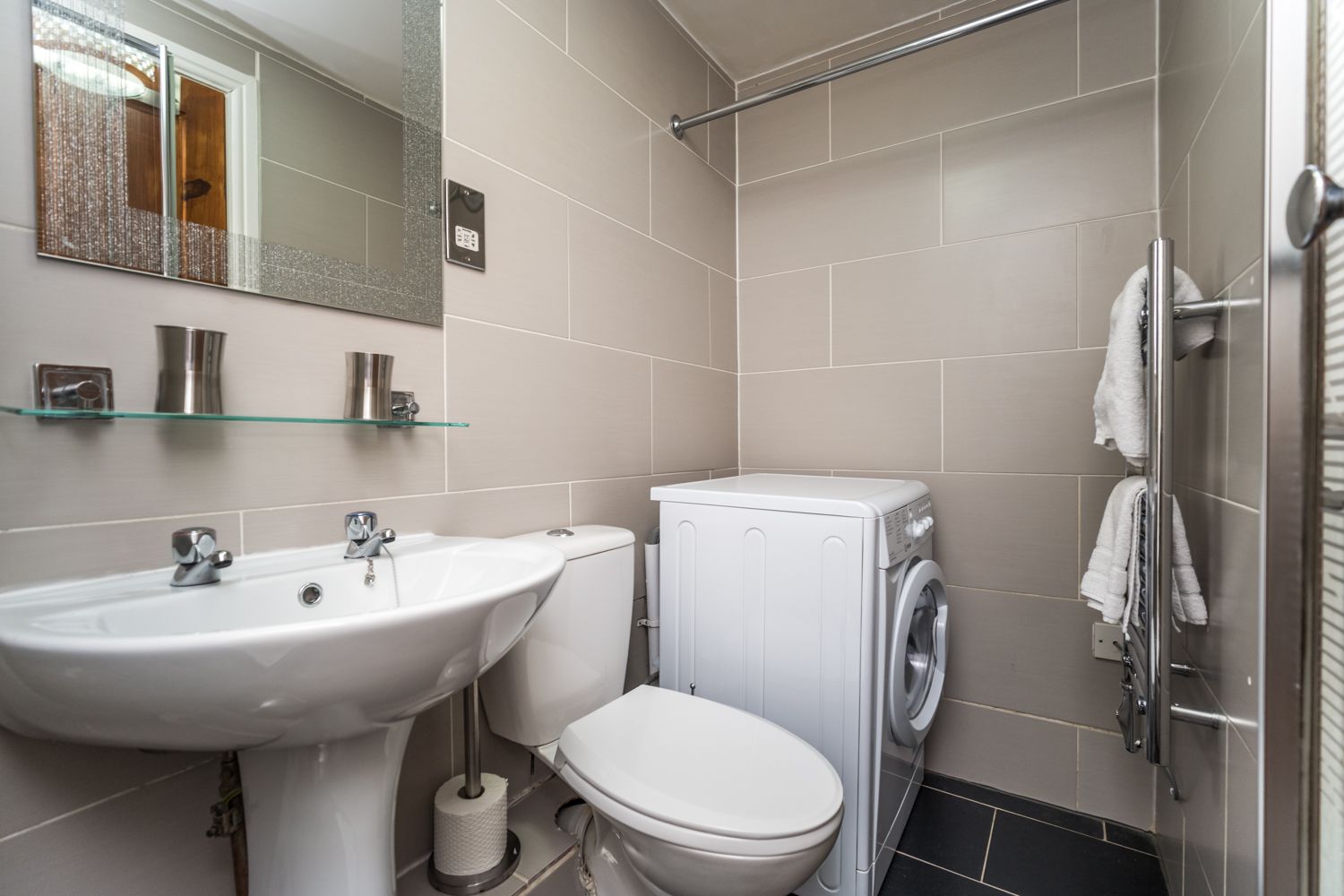 There is a small utility area at the far end of the shower room