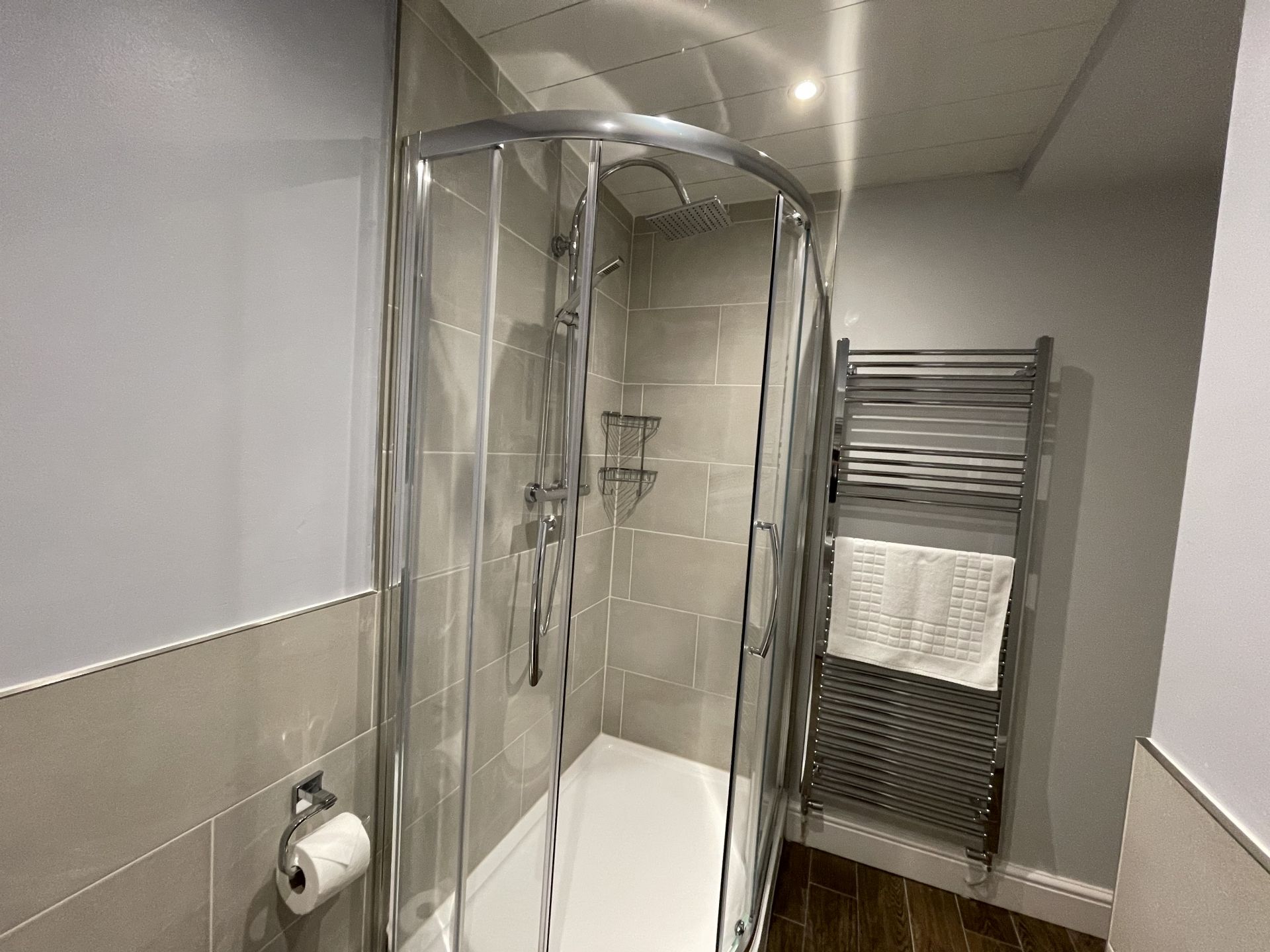 A large walk in shower in the ensuite bathroom
