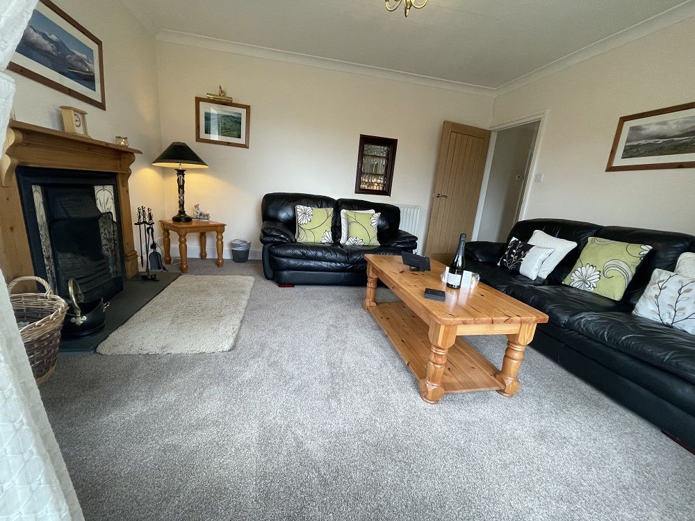 he lounge is homely and bright, with two comfortable leather settees and a lovely open fireplace perfect for cosy Winter nights